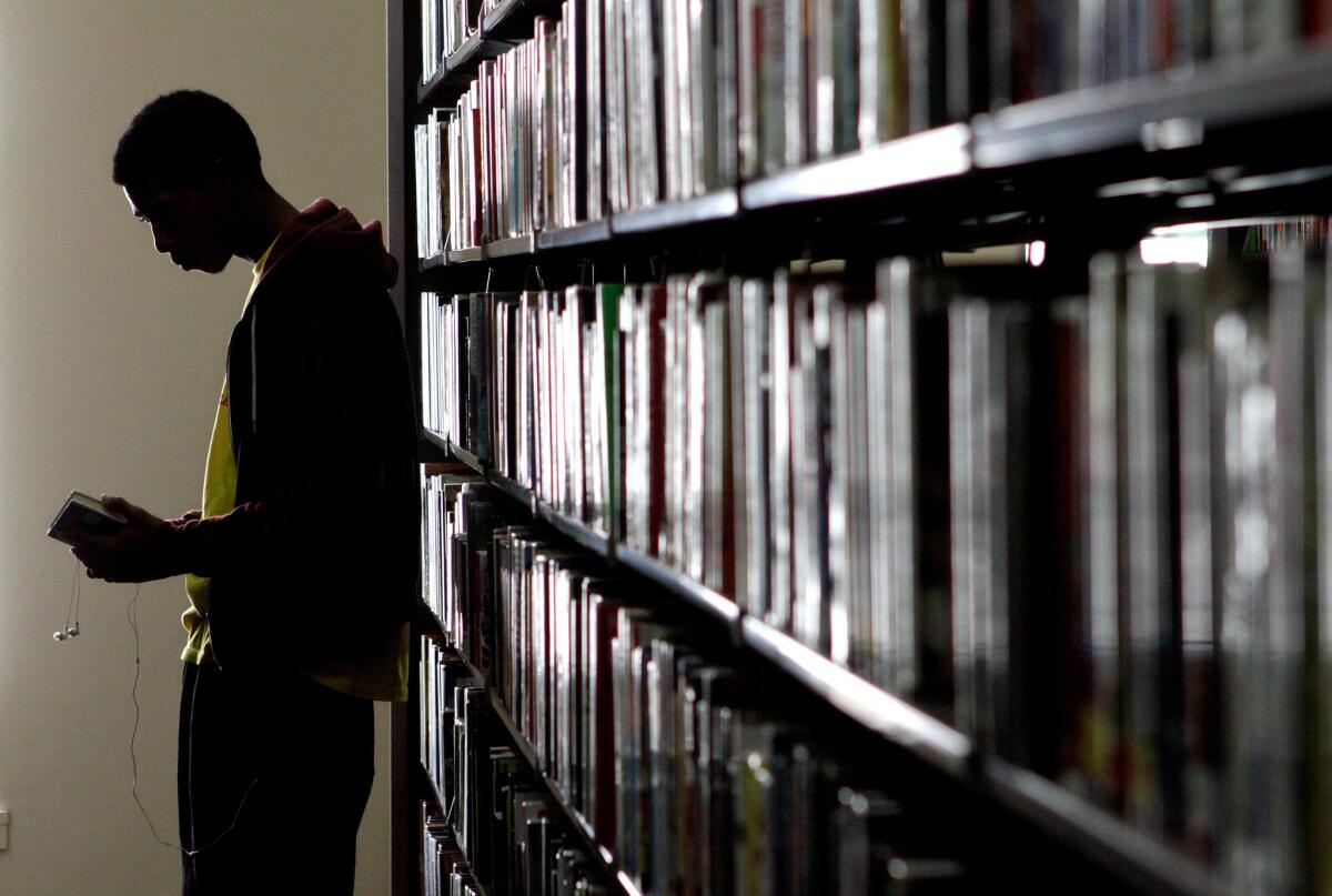 A man browses the shelves in the fiction department at the Central Library in Los Angeles.