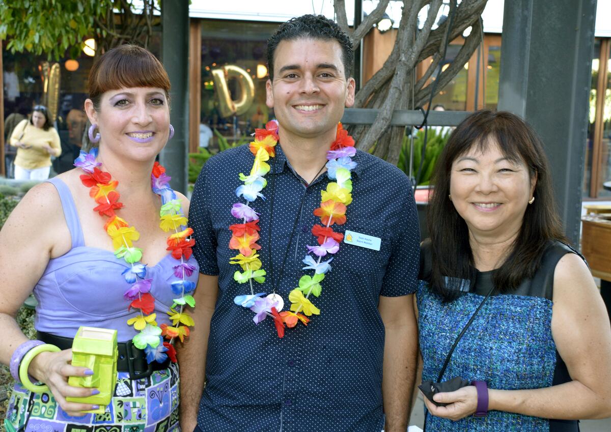 Welcoming supporters to the “Casino Paradise” fundraiser on Saturday were, from left, Silvia Mancini, Sean Aquino and Dale Morimizu Gorman.