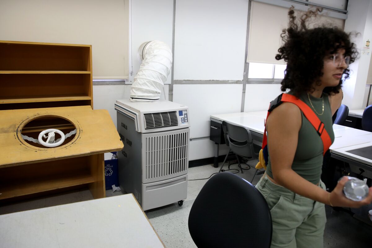 A portable air conditioner is used in a classroom.
