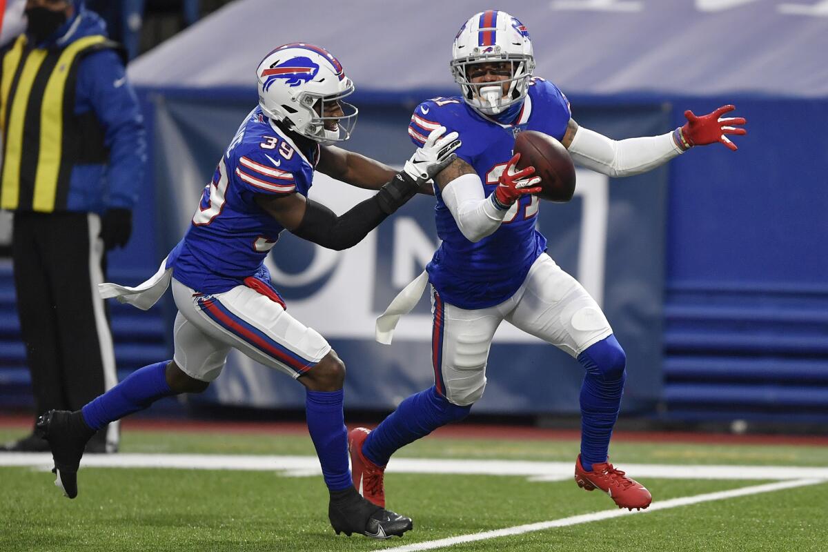 Buffalo Bills strong safety Dean Marlowe, right, celebrates with teammate Levi Wallace after recovering a fumble.