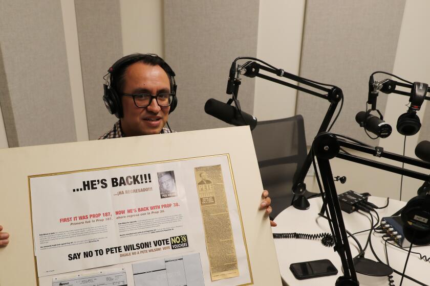 Gustavo Arellano,holding a posterboard with his first-ever journalism article. The subject? Pete Wilson