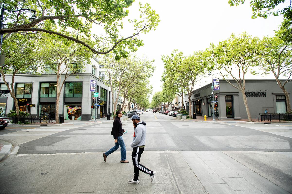 Pedestrians cross University Avenue in Palo Alto. Senate Bill 50 could clear the way for higher-density housing in the area.