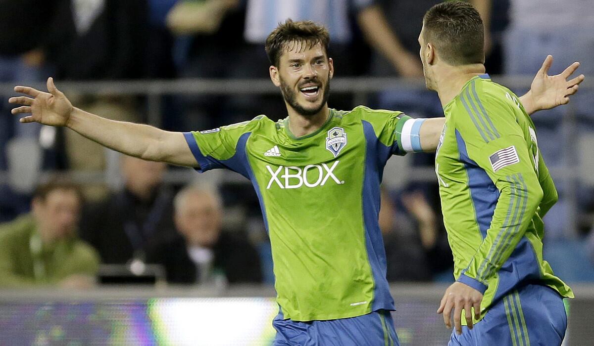 Sounders defender Brad Evans, celebrating with teammate Kenny Cooper (right) after he scored a goal, is fighting for one of the remaining spots on the U.S. roster for the World Cup.