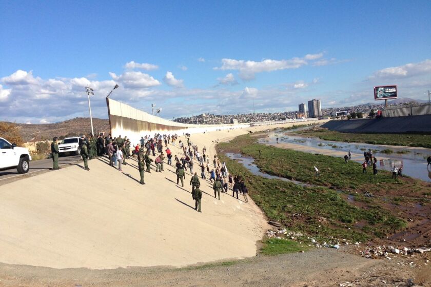 Border Patrol agents respond to a crowd one-eighth of a mile north of the U.S.-Mexico border in the Tijuana River channel. / U.S. Customs and Border Protection photo