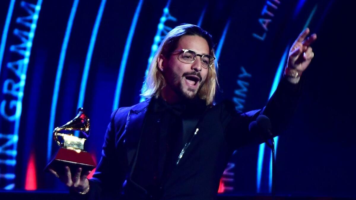 Maluma accepts the contemporary pop vocal album award at the 19th Annual Latin Grammy Awards in Las Vegas.