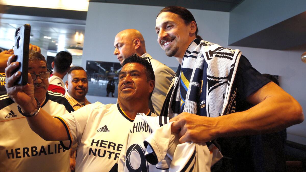 Zlatan Ibrahimovic poses for photos with fans after the Galaxy's introductory news conference at the StubHub Center on Friday.