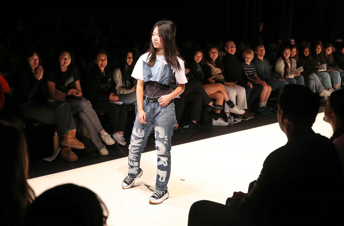 Student model Kayla Chan walks the runway Friday during the fashion show at Sage Hill.