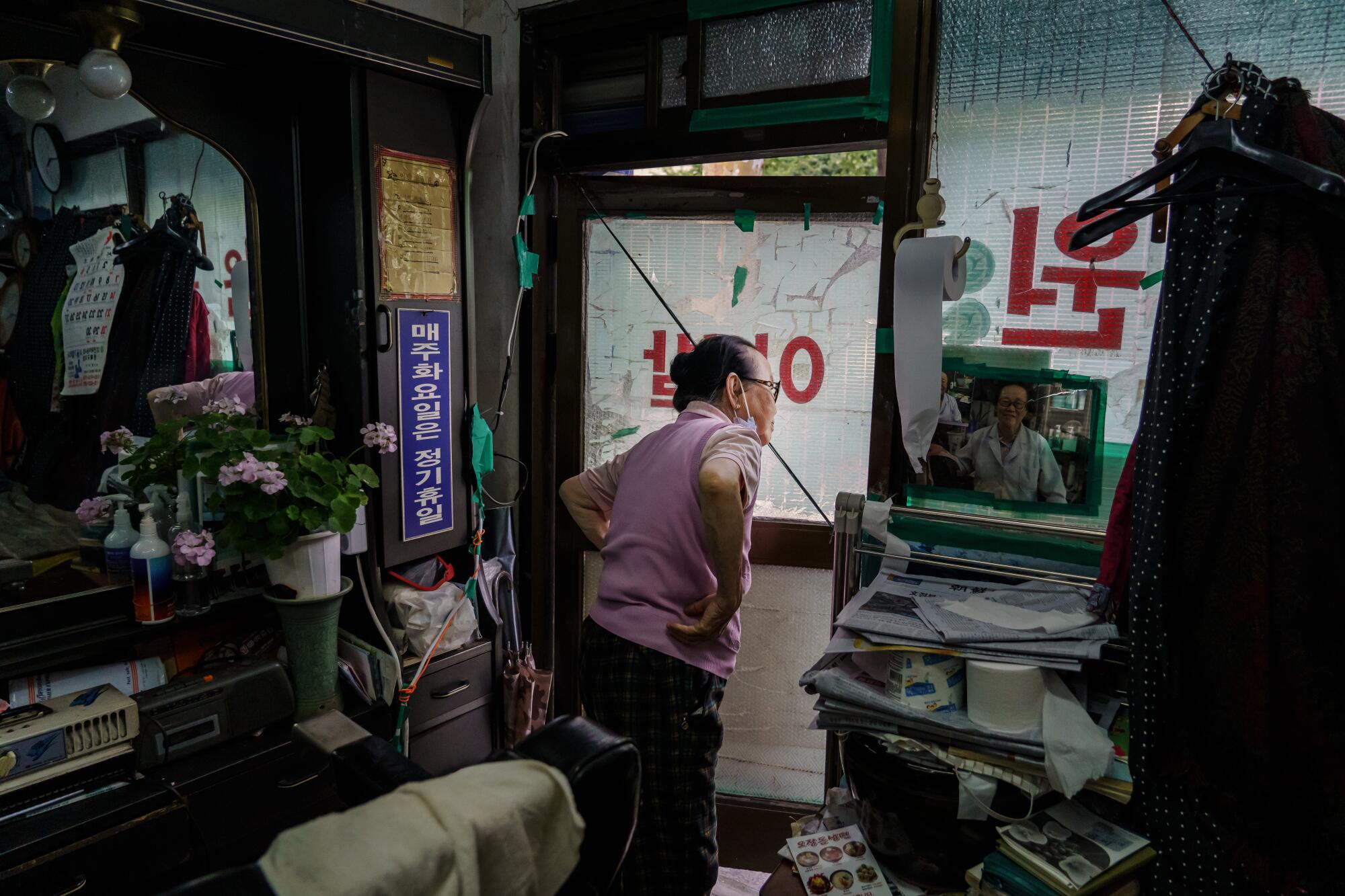 Lee Duk-hoon waits for customers at barbershop in Seoul.