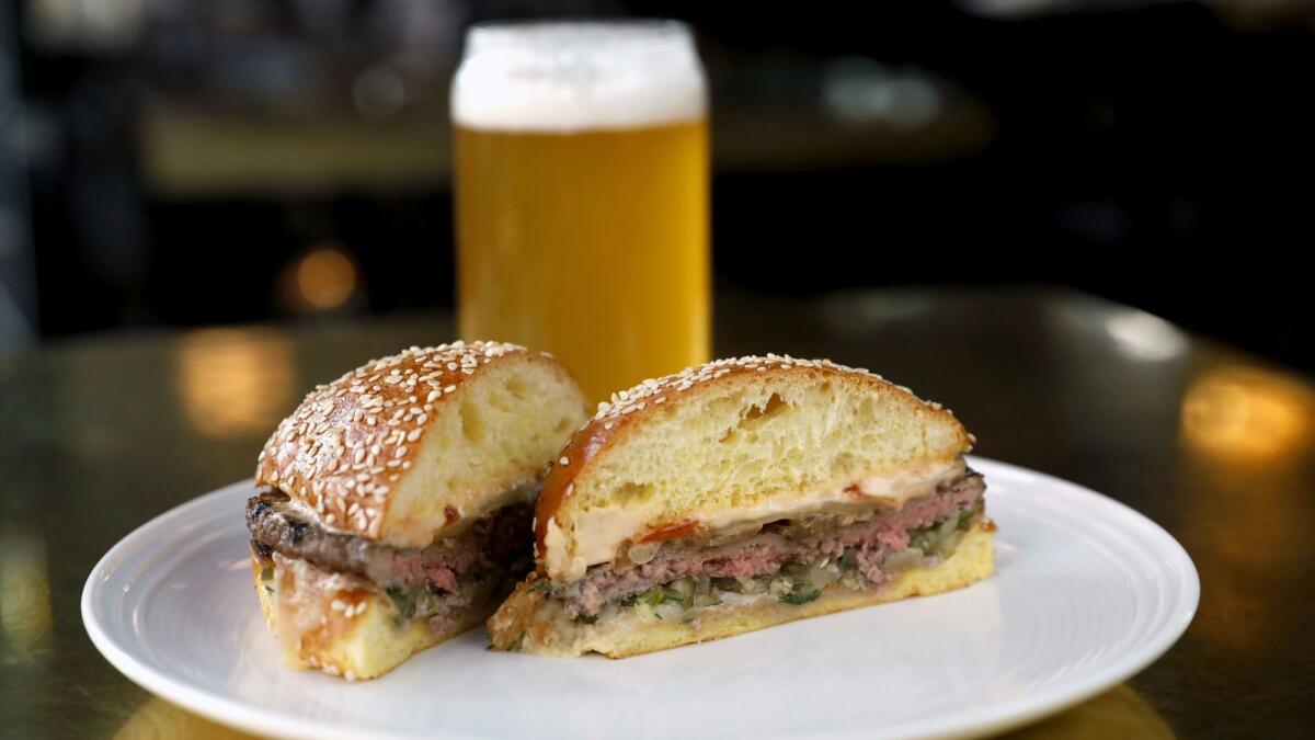 The BTU burger with caramelized onion, dill relish, umeboshi mayo and Cabot cheddar at Best Girl.