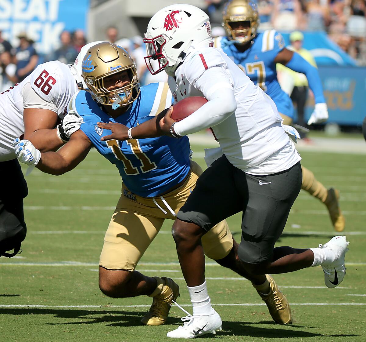 UCLA linebacker Gabriel Murphy closes in before sacking Washington State Cougars quarterback Cameron Ward.