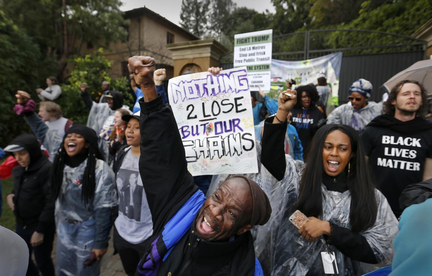 Black Lives Matter protester Lee Maupin, center, joins others chanting in front of the Bel Air mansion of President Trump's Treasury Secretary pick, Steven Mnuchin Friday