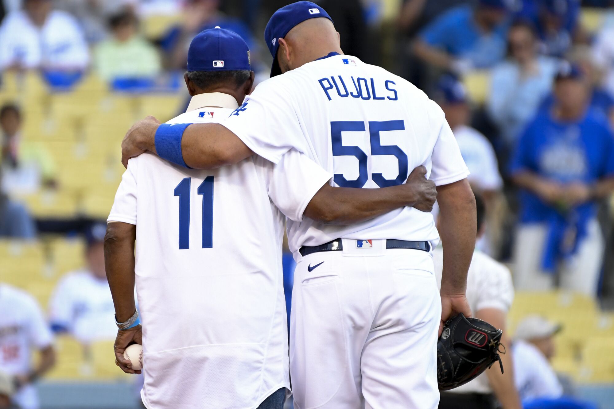  Dodgers' Albert Pujols hugs Manny Mota.