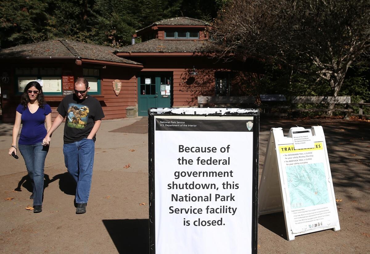 Visitors leave at Muir Woods National Monument Wednesday in Mill Valley, Calif., after discovering that it is closed. Muir Woods and all federal museums and parks across the nation were closed for a second day due to the partial government shutdown.