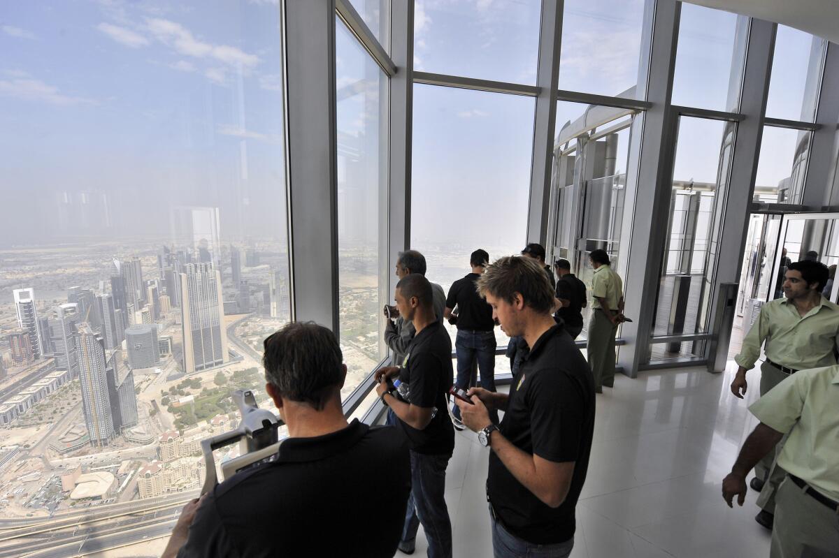 Visitors take in the view from the observation deck at Burj Khalifa in Dubai, the world's tallest building.