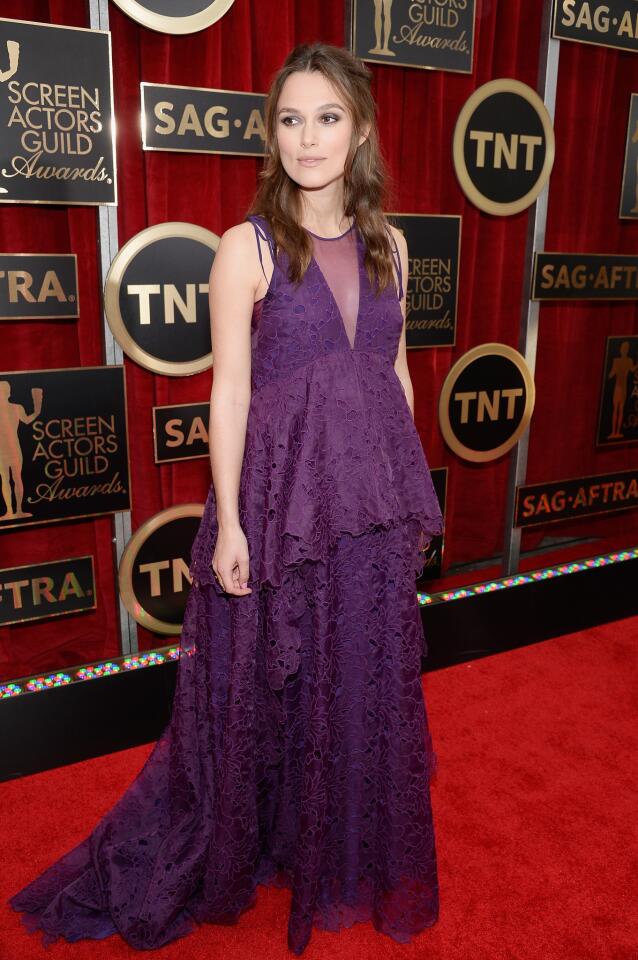 An expecting Keira Knightley wore a glorious plum-colored tiered lace Erdem gown.