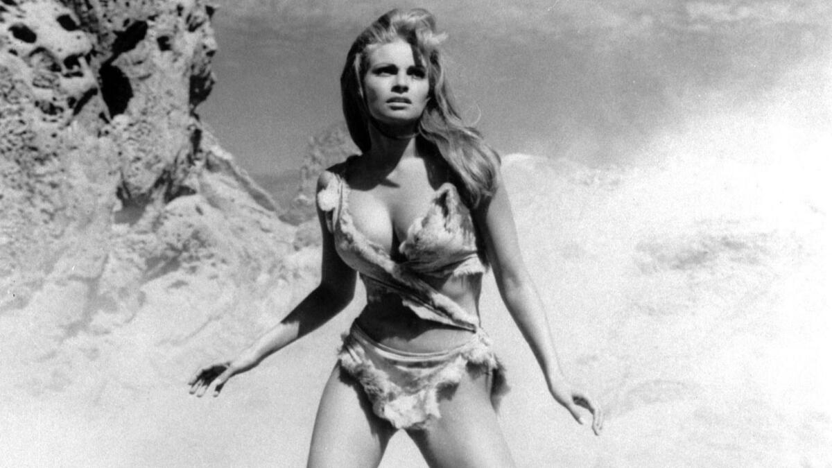 A black-and-white film still of a woman in a bikini