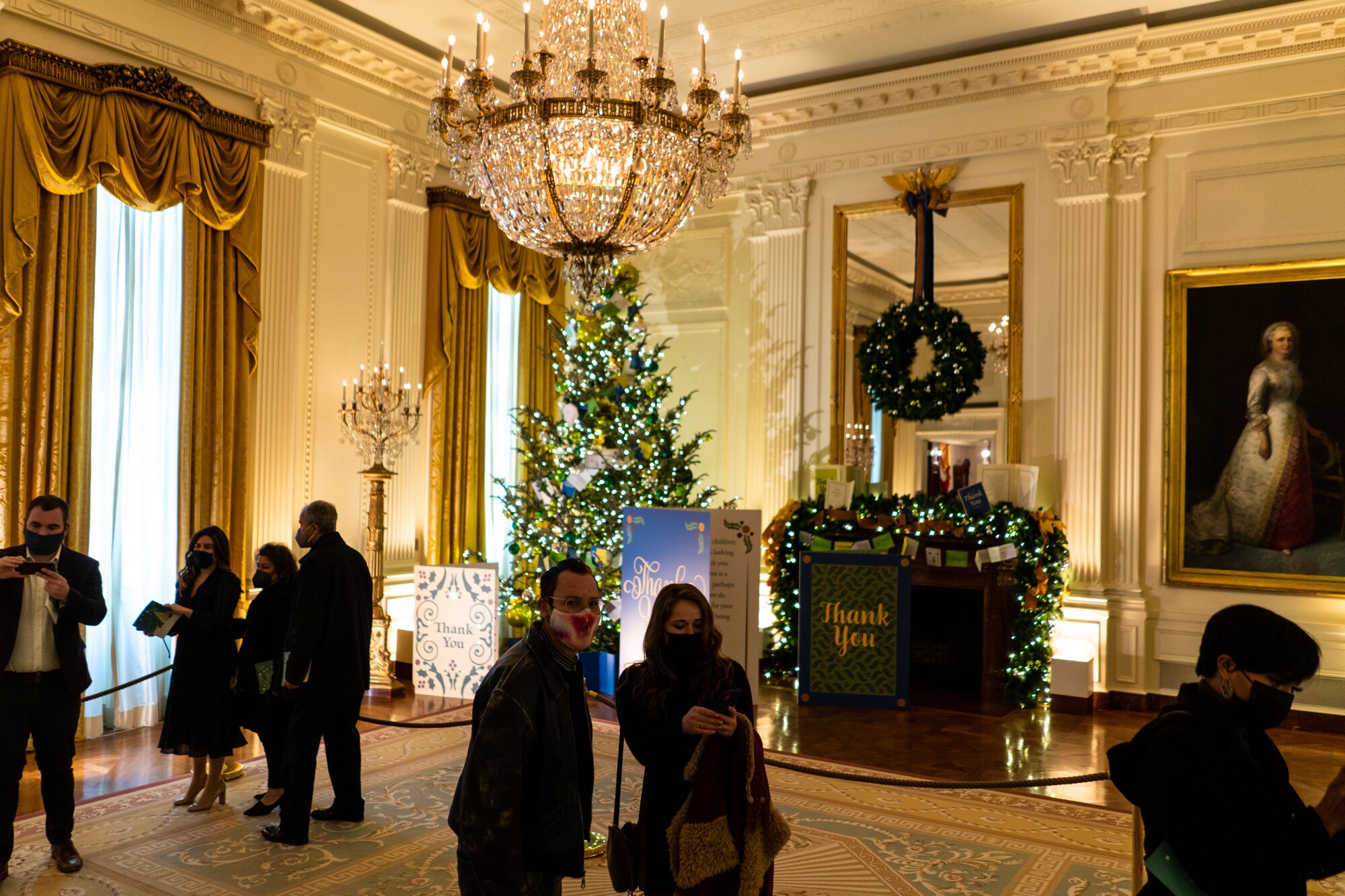 Visitors admire Christmas decorations in the East Room of the White House.