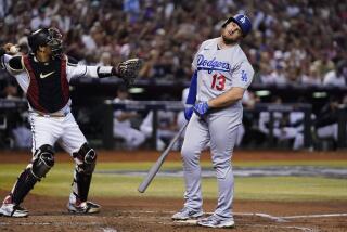 Los Angeles Dodgers' Max Muncy (13) reacts after a foul tip was caught by Arizona Diamondbacks catcher Gabriel Moreno, left, during the fourth inning in Game 3 of a baseball NL Division Series, Wednesday, Oct. 11, 2023, in Phoenix. (AP Photo/Ross D. Franklin)