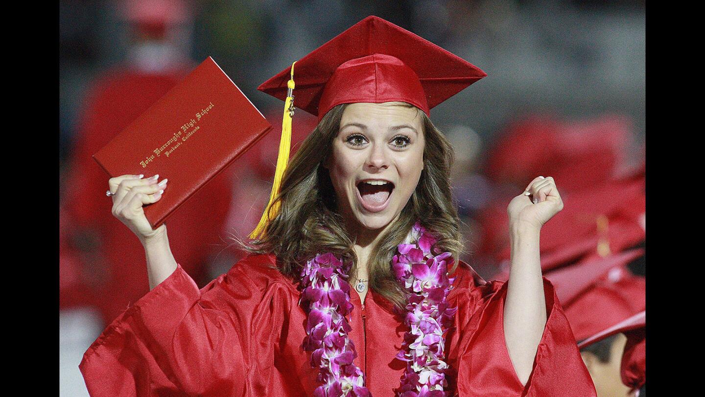 Graduate Mattie Motz, 18, reacts after graduating and receiving her diplma at the graduation Burroughs High School's class of 2016 on the football field at the high school on Thursday, May 26, 2016.