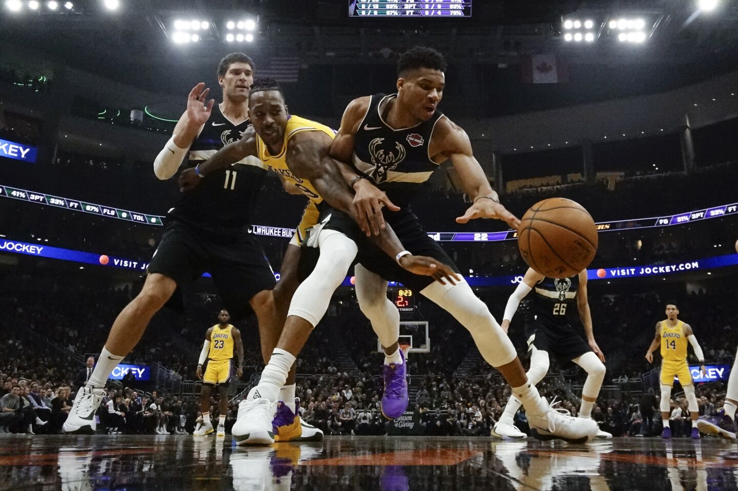 Bucks forward Giannis Antetokounmpo and Lakers center Dwight Howard battle for a loose ball during the first half of a game Dec. 19.
