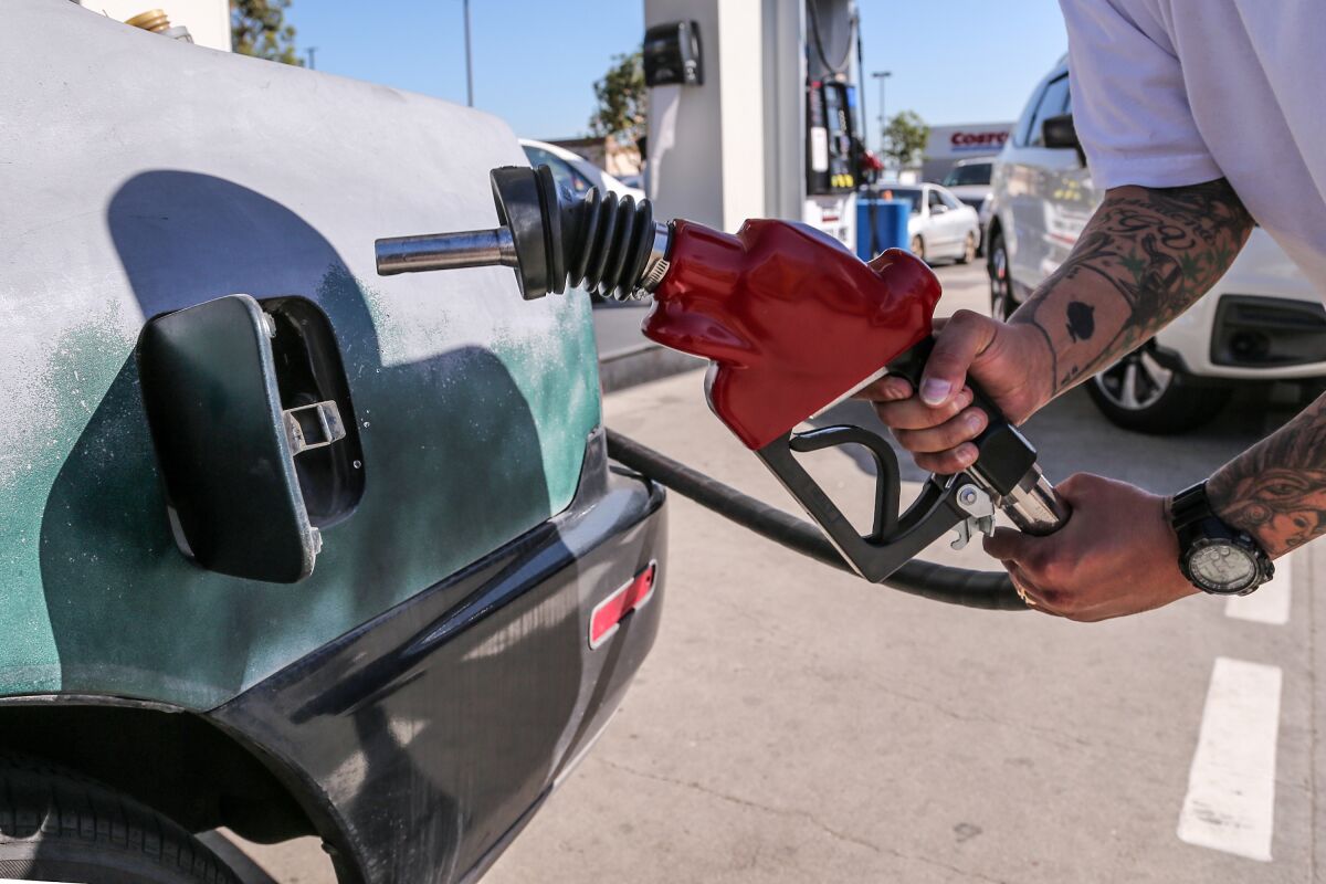 A man puts gas in his car.