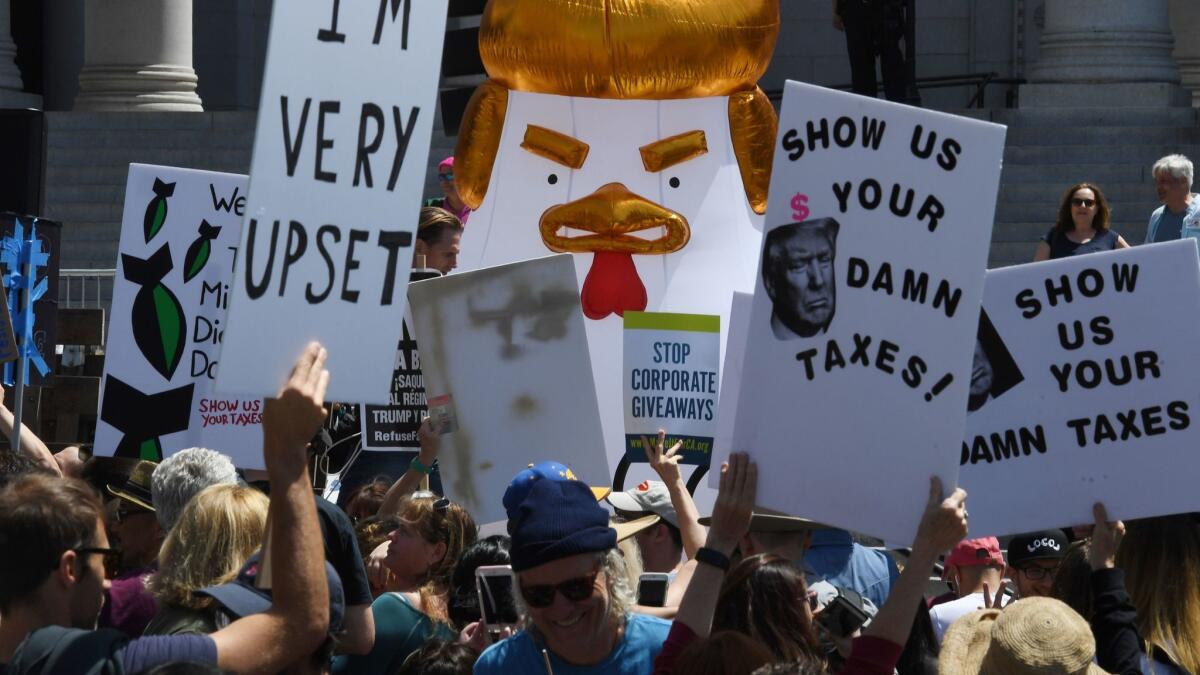 In Los Angeles, protesters take part in the April 15 Tax March calling on President Trump to release his tax returns.