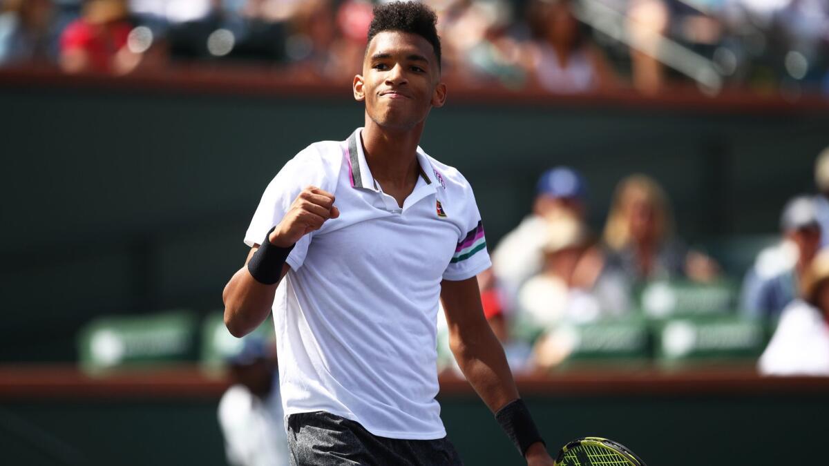 Felix Auger-Aliassime celebrates match point against Stefanos Tsitsipas during their men's singles second-round match at the BNP Paribas Open on Saturday at Indian Wells.