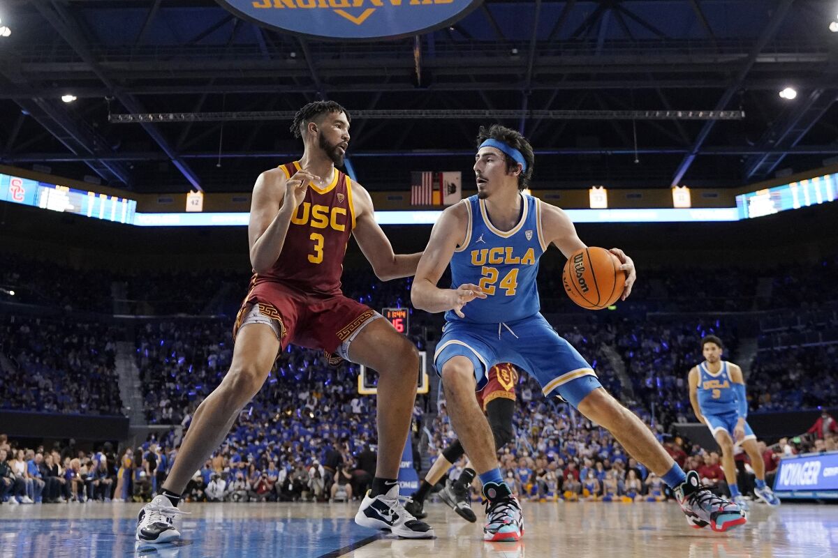 UCLA guard Jaime Jaquez Jr., right, controls the ball in front of USC forward Isaiah Mobley during the second half.