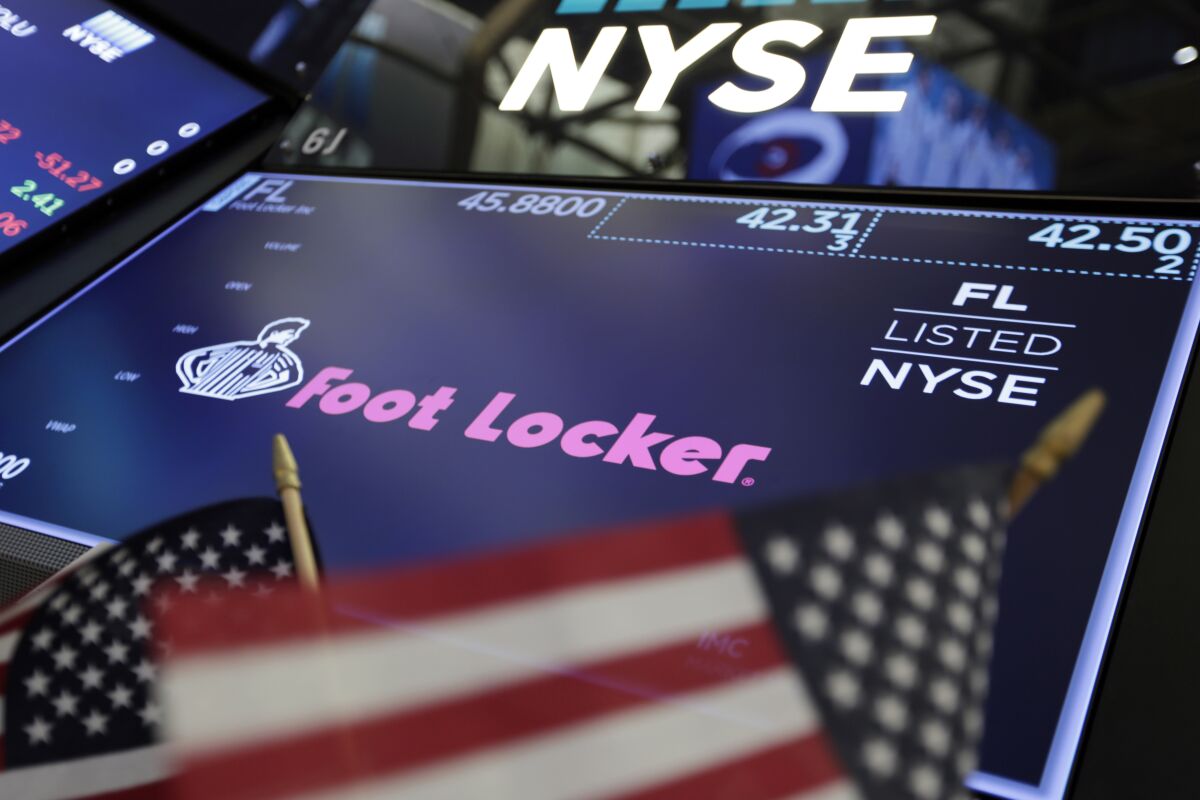 FILE - In this March 2, 2018 file photo, the logo for Foot Locker appears above a trading post on the floor of the New York Stock Exchange. Foot Locker’s second-quarter comparable sales rose about 18%, helped by pent-up demand and the effect of the fiscal stimulus. Analysts polled by FactSet predict a 9.1% decline. The footwear company said Monday, Aug. 10, 2020, that its quarterly adjusted profit is anticipated in a range of 66 cents to 70 cents per share. (AP Photo/Richard Drew, File)