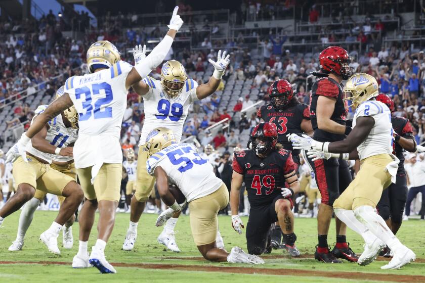 San Diego, CA - September 09: UCLA Bruins players celebrate an interception against San Diego State during their game at Snapdragon Stadium on Saturday, Sept. 9, 2023 in San Diego, CA. (Meg McLaughlin / The San Diego Union-Tribune)