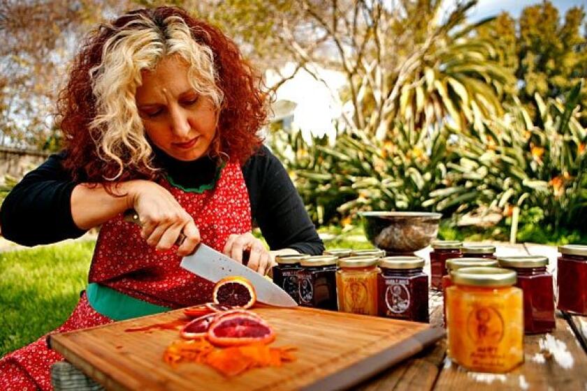 Laura Ann Masura cuts into a blood orange as she prepares one of her special jams.