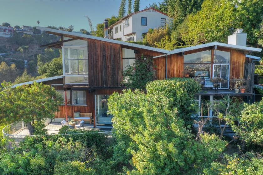 Built in 1951, the Midcentury post-and-beam features an eye-catching exterior of wood and glass.
