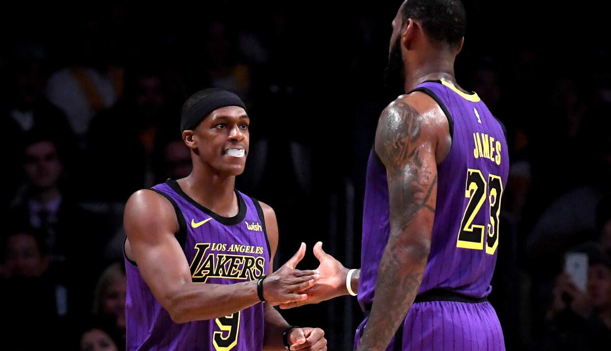 Lakers guard Rajon Rondo receives congratulations from teammate LeBron James after scoring against the New Orleans Pelicans during the first half Friday.