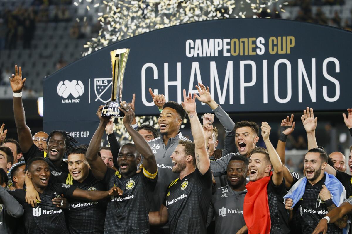 The Columbus Crew celebrate after winning the Campeones Cup soccer game following a 2-0 victory over Cruz Azul Wednesday, Sept. 29, 2021 at Lower.com Field in Columbus, Ohio. The Crew won 2-0. (Joshua A. Bickel/The Columbus Dispatch via AP)