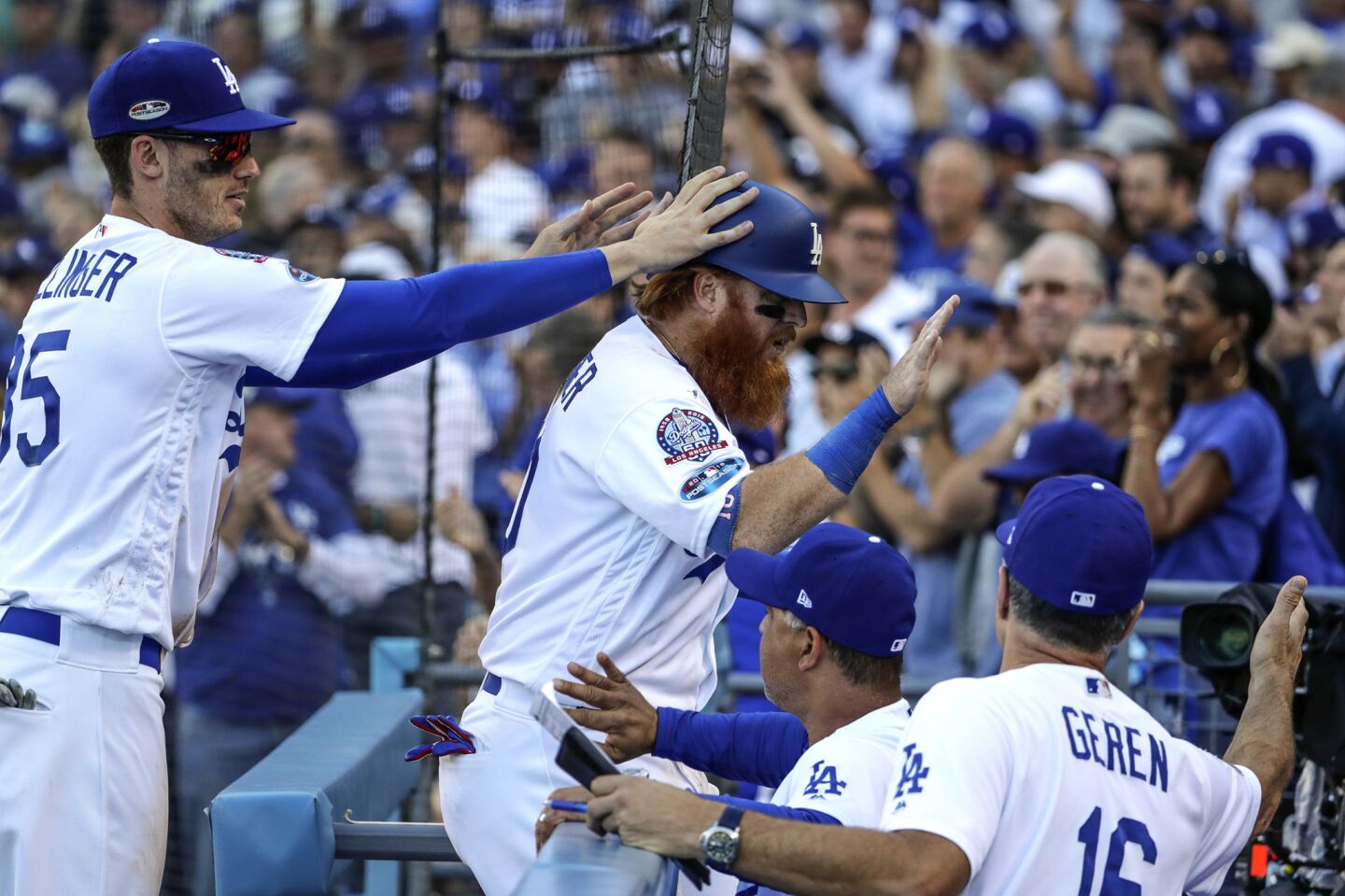 Dodgers Justin Turner is congratulated after scoring a run in the sixth inning.