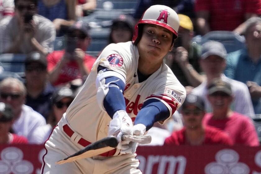 Los Angeles Angels' Shohei Ohtani breaks his bat as he hits a single during the first inning.