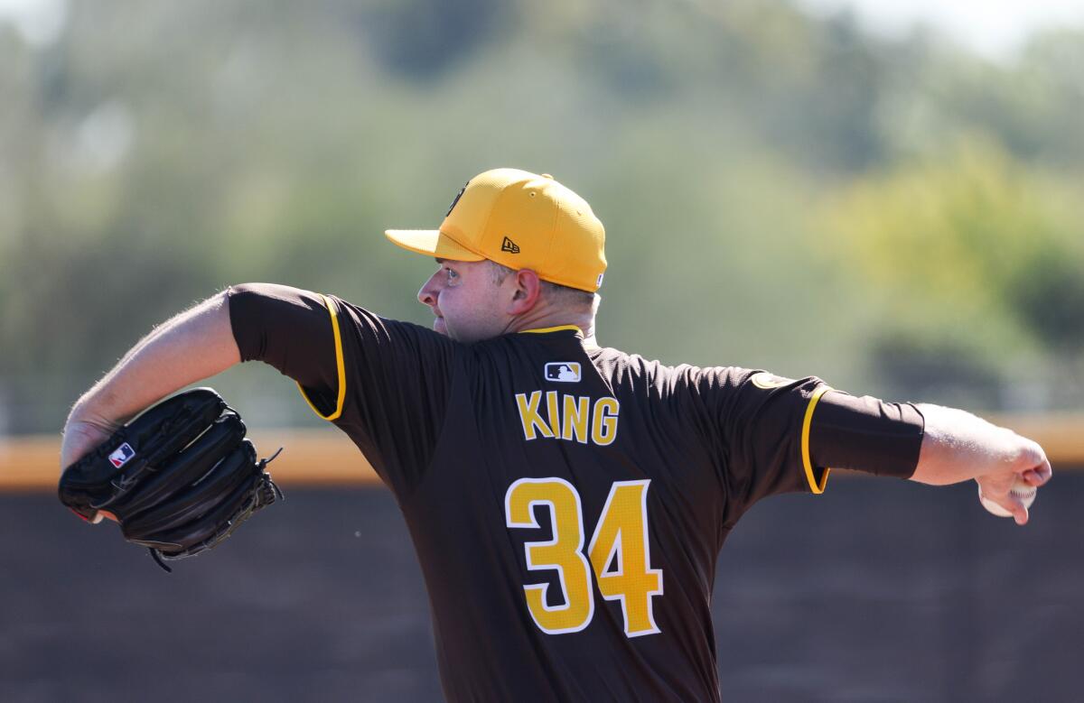 Michael King pitches during spring training workouts.