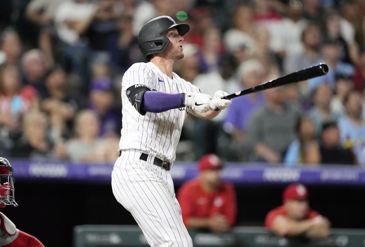 Colorado Rockies' Ryan McMahon follows the flight of his two-run home run off St. Louis Cardinals relief pitcher T.J. McFarland in the seventh inning of a baseball game Tuesday, Aug. 9, 2022, in Denver. (AP Photo/David Zalubowski)