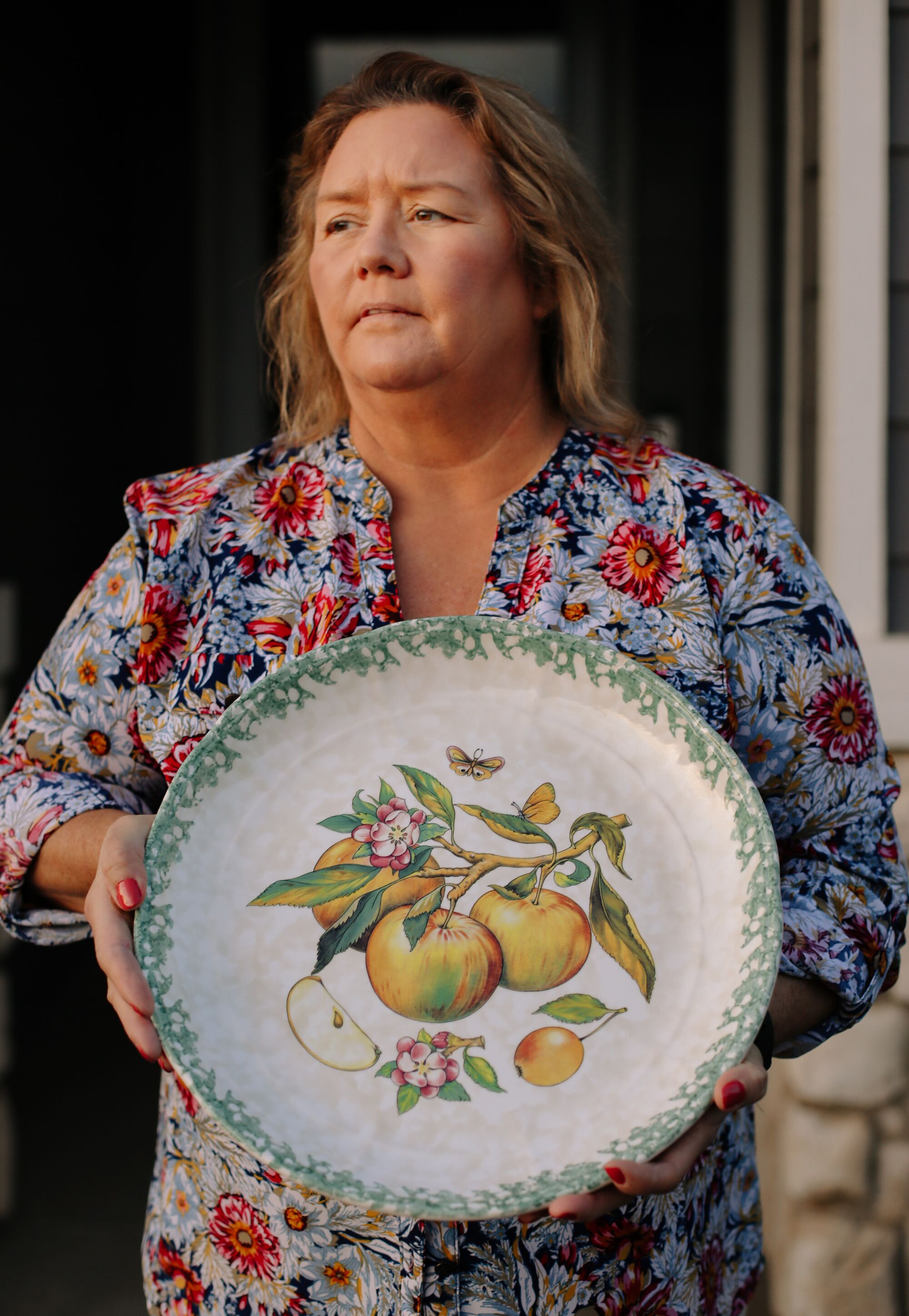 A woman holds a platter for a portrait