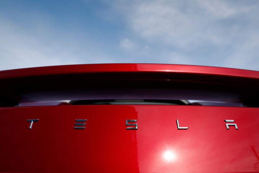 FILE - In this April 15, 2018 file photo, the sun shines off the rear deck of a roadster on a Tesla dealer's lot in the south Denver suburb of Littleton, Colo. Tesla has picked Austin, Texas, and Tulsa, Oklahoma, as finalists for its new U.S. assembly plant, a person briefed on the matter said Friday, May 15, 2020. (AP Photo/David Zalubowski, File)