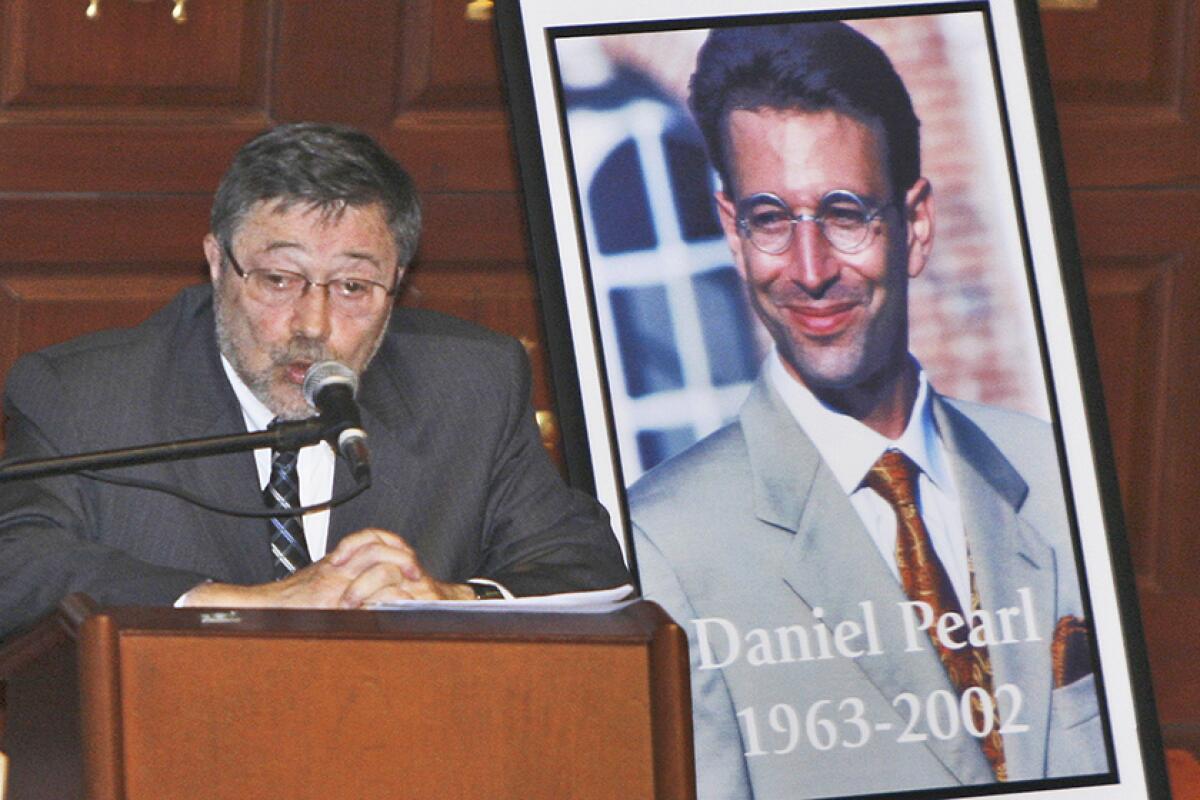 Dr. Judea Pearl, father of Daniel Pearl, speaks in 2007 next to a portrait of his son.
