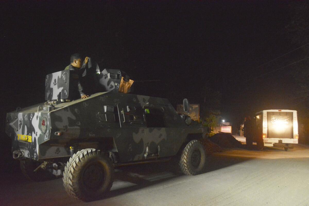 Philippine marines escort a police van believed to be carrying the body of German hostage Juergen Gustav Kantner in 2017.