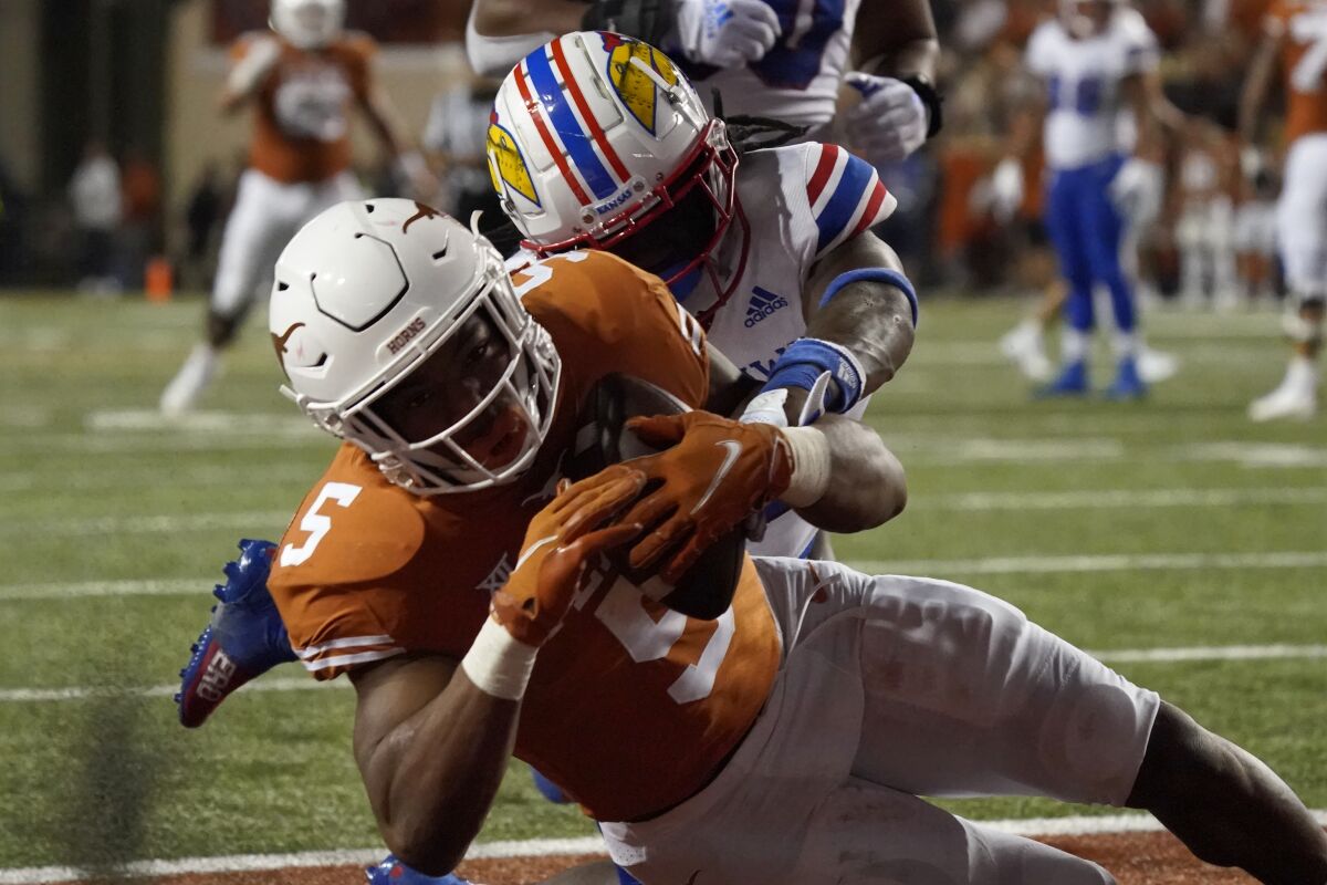Texas running back Bijan Robinson (5) catches a touchdown pass against Kansas during the second half of an NCAA college football game in Austin, Texas, Saturday, Nov. 13, 2021. (AP Photo/Chuck Burton)