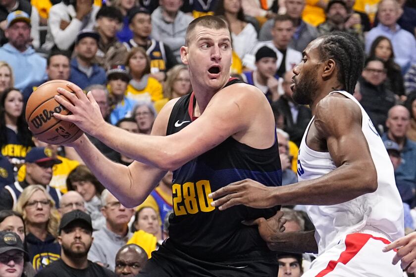 Denver Nuggets center Nikola Jokic is pressured by Los Angeles Clippers forward Kawhi Leonard during the first half of an NBA basketball in-season tournament game Tuesday, Nov. 14, 2023, in Denver. (AP Photo/Jack Dempsey)