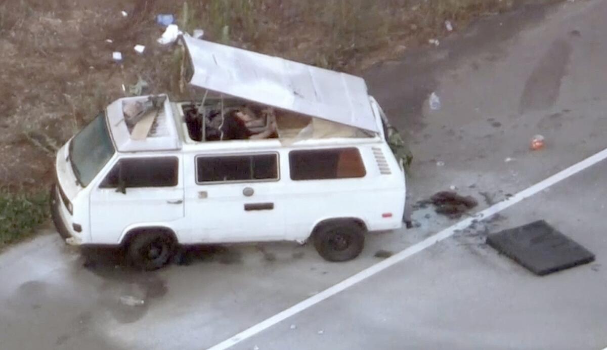 A white van with its pop-up roof raised is seen from the air.