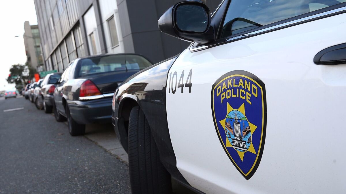 A patrol car sits in front of the Oakland Police headquarters. A linguistic analysis of body camera footage shows that Oakland officers treat black motorists with less respect than white motorists.