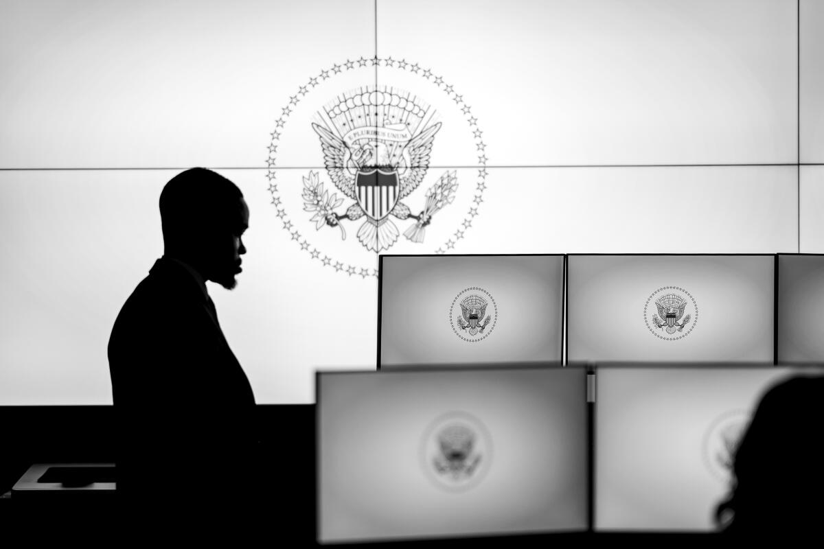 A person stands in a White House operations center.