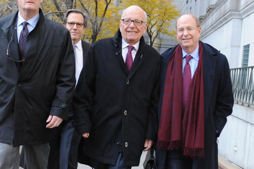 Rupert Murdoch, center, exits state Supreme Court on Wednesday in New York. Murdoch and his soon-to-be former wife said they were parting with "mutual respect" Wednesday after telling a judge they had reached a divorce deal.