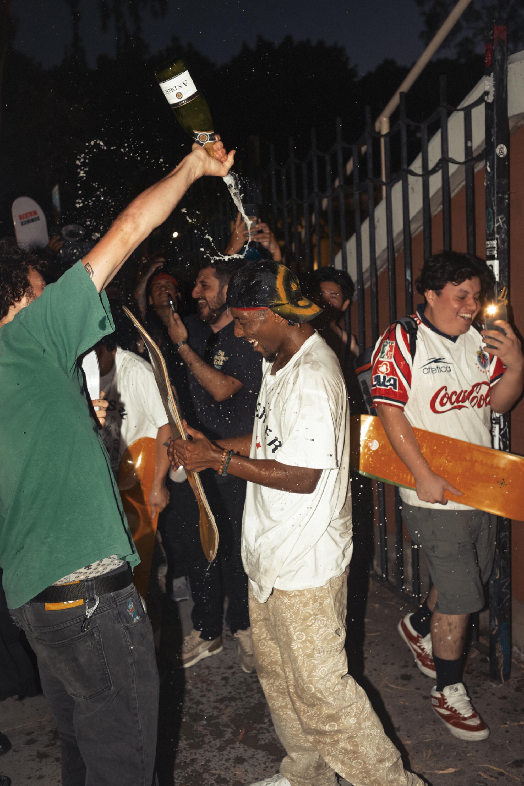 Domo Walker gets champagne poured on him.