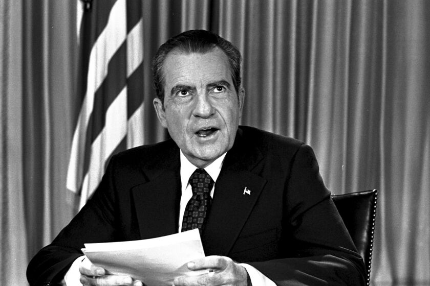 FILE - President Richard Nixon sits in his White House office, Aug. 16, 1973, as he poses for pictures after delivering a nationwide television address dealing with Watergate. In 1974, Richard Nixon faced possible charges for a wide range of alleged wrongdoing, from bribery to obstruction of justice, when Gerald Ford pardoned him just weeks after he resigned. (AP Photo, File)